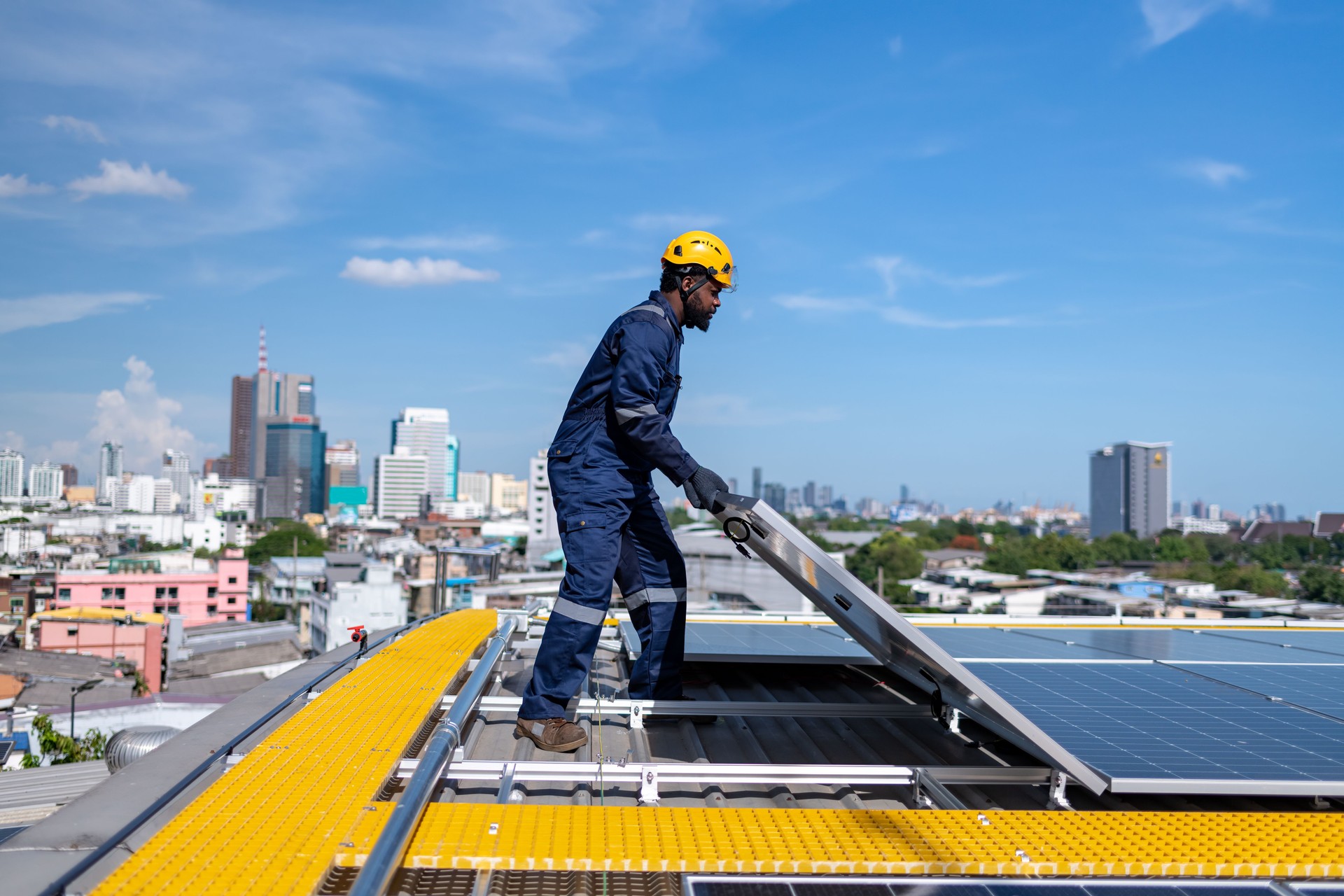 Engineers walking on roof inspect check and maintenance solar cell panel by hold equipment and cordless drill ,solar cell is smart grid ecology energy sunlight alternative power factory concept
