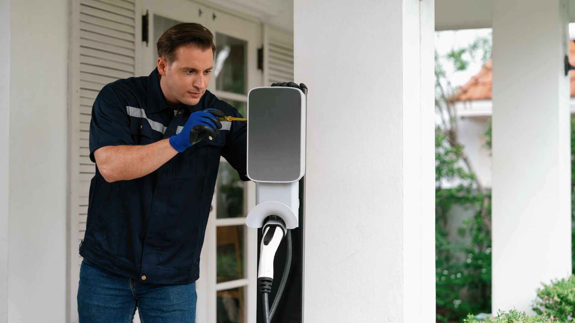 Qualified technician install home EV charging station. Synchronos